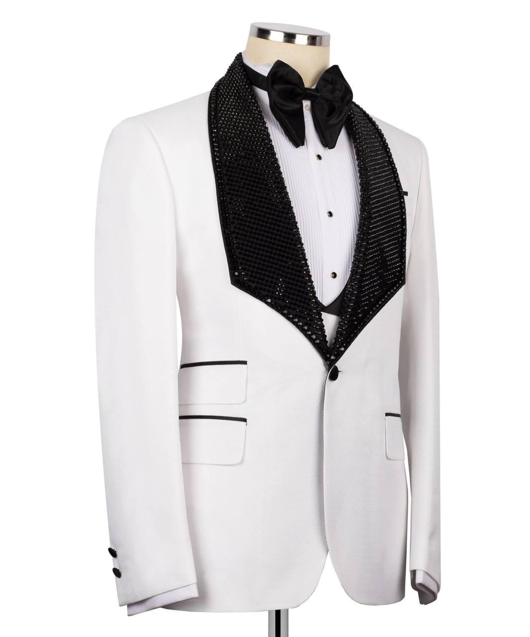White tuxedo jacket with black lapels and bow tie on a mannequin against a white background