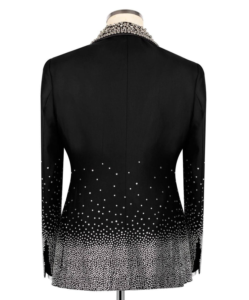 Black long-sleeve blazer shown from the back on a mannequin, featuring a beaded collar and a sparkling gradient pattern that fades from dense at the hem and cuffs to sparse near the shoulders.