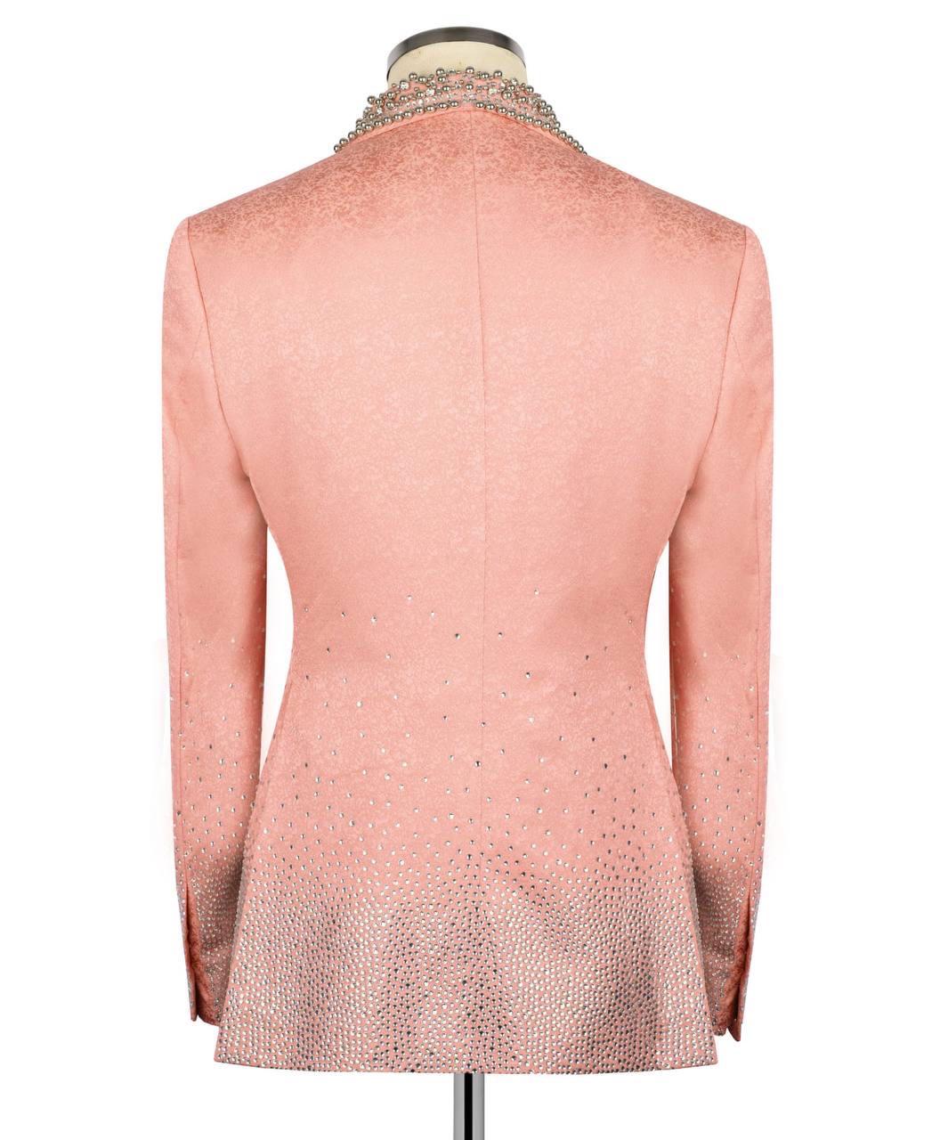 Pink blazer with intricate detailing on a mannequin against a white background