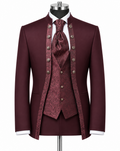 A formal three-piece suit displayed on a mannequin, featuring a deep burgundy jacket, matching waistcoat, and patterned tie, with white shirt cuffs and a white dress shirt visible.