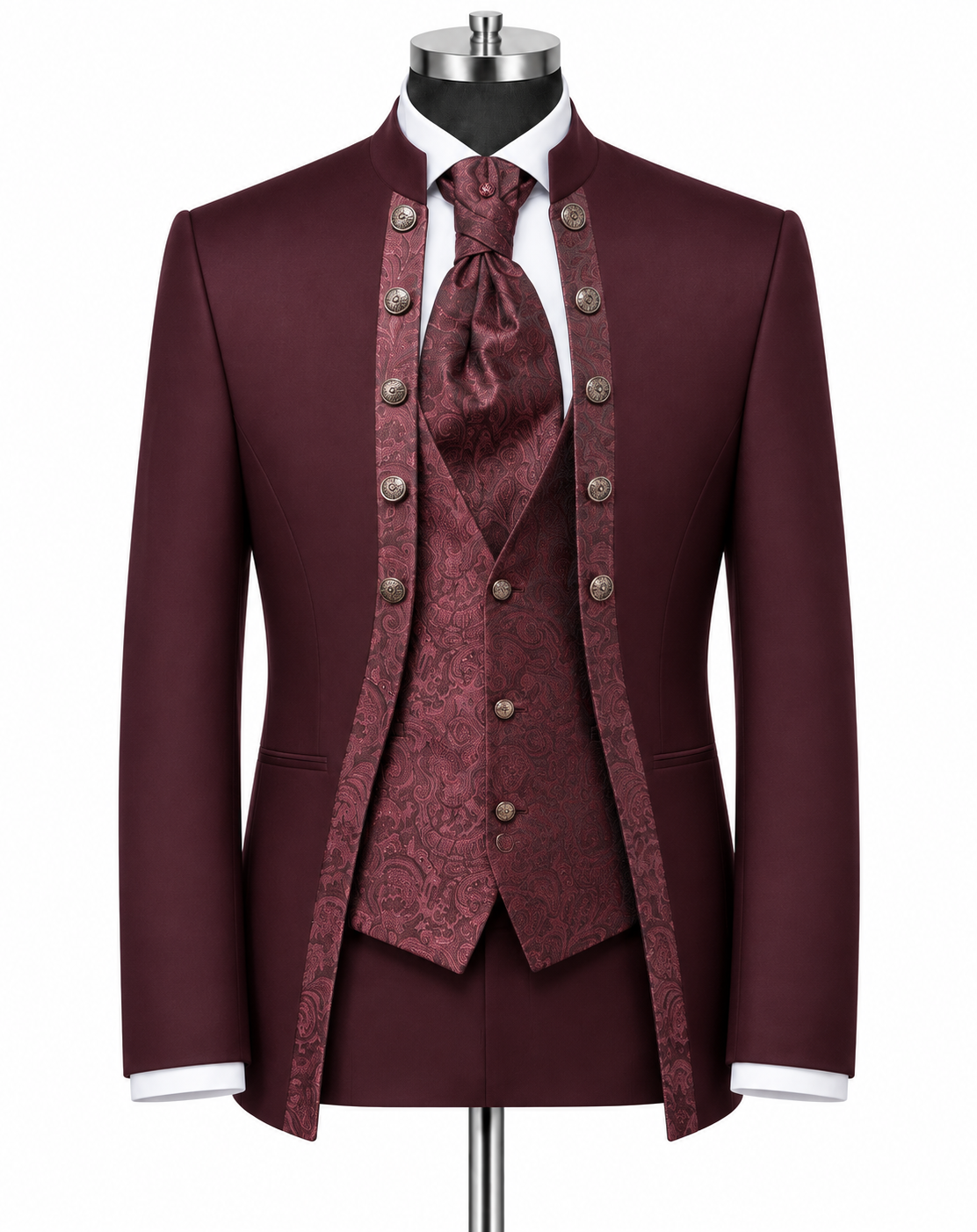 A formal three-piece suit displayed on a mannequin, featuring a deep burgundy jacket, matching waistcoat, and patterned tie, with white shirt cuffs and a white dress shirt visible.