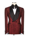 A men's double-breasted tuxedo jacket in a deep red brocade fabric with black satin peak lapels, styled on a mannequin with a black bow tie and white dress shirt against a plain white background.