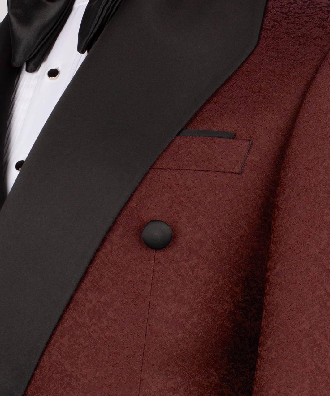 Close-up of a maroon tuxedo jacket with black lapels and buttons.