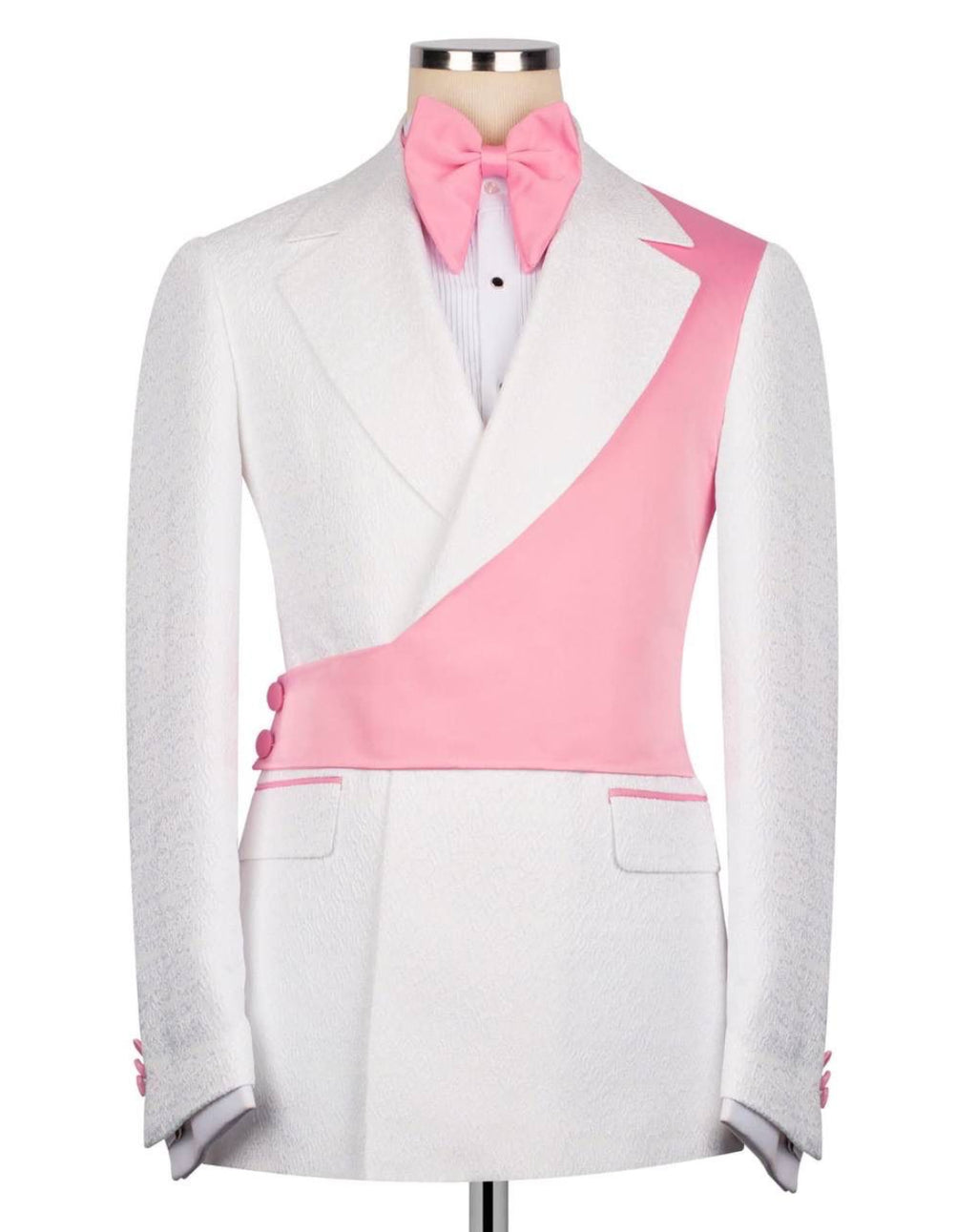 A white tuxedo jacket with a diagonal pink wrap detail, styled on a mannequin with a pink bow tie and white pleated shirt against a white background.