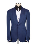 A men's blue textured tuxedo jacket displayed on a mannequin torso, styled with a white dress shirt, black bow tie, and black studs, against a plain white background.