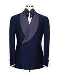 A men's navy blue tuxedo jacket with a satin peak lapel in a muted purple-gray color, styled on a mannequin with a white dress shirt, dark bow tie, and white cufflinks.