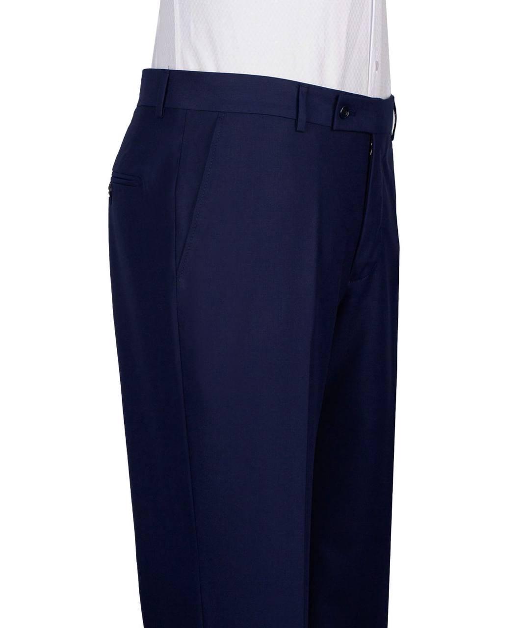 A close-up side view of a person wearing navy blue dress pants with a white shirt visible at the top, shown against a plain white background.