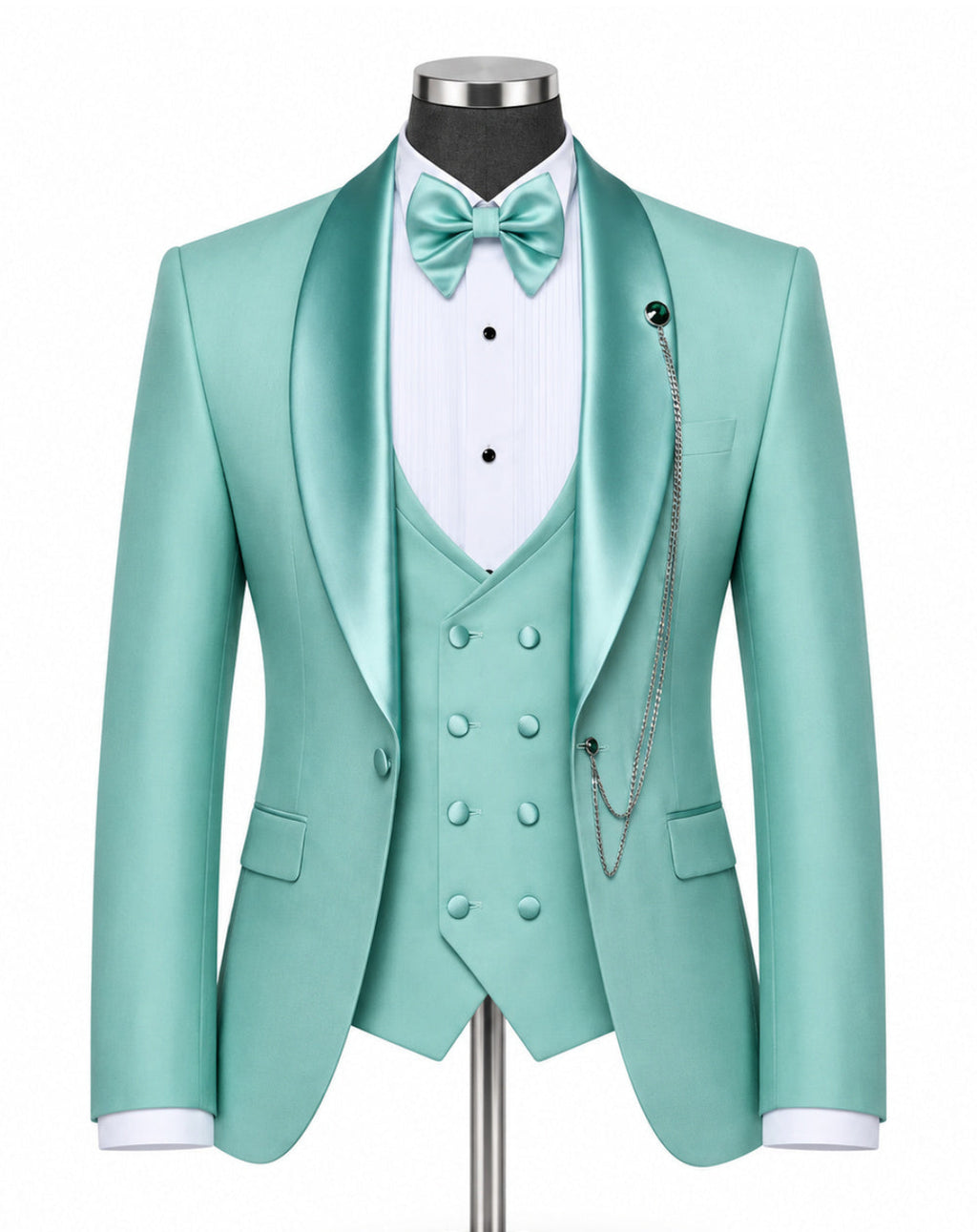 A mint green satin formal suit displayed on a mannequin, featuring a double-breasted jacket, matching vest, white pinstripe shirt, mint green bow tie, and silver chain detail against a white background.