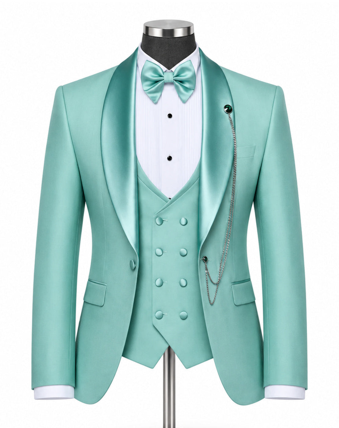 A mint green satin formal suit displayed on a mannequin, featuring a double-breasted jacket, matching vest, white pinstripe shirt, mint green bow tie, and silver chain detail against a white background.