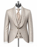 A men's formal suit displayed on a mannequin, featuring a light beige textured jacquard jacket with shawl lapels, a matching double-breasted waistcoat, a white dress shirt, and a beige tie.
