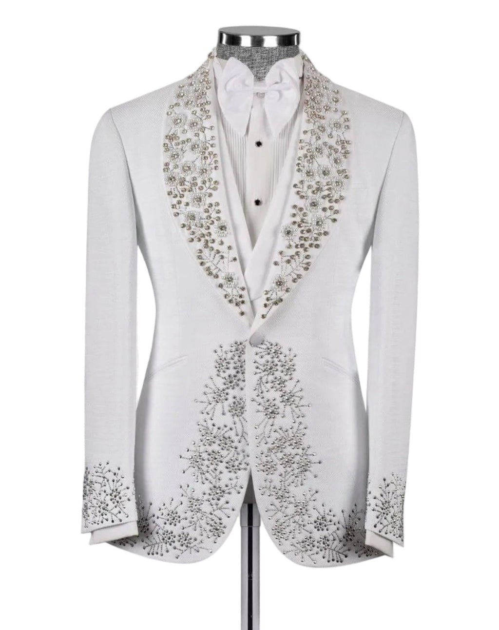 A white tuxedo jacket with elaborate silver and gold floral beadwork on the shawl collar and front panels, displayed on a mannequin with a white shirt and bow tie against a light gray background.