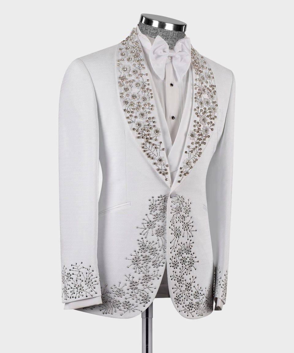 A white formal tuxedo jacket with ornate silver and gold beaded floral patterns on the shawl collar, front, and cuffs, displayed on a mannequin with a white shirt and bow tie.