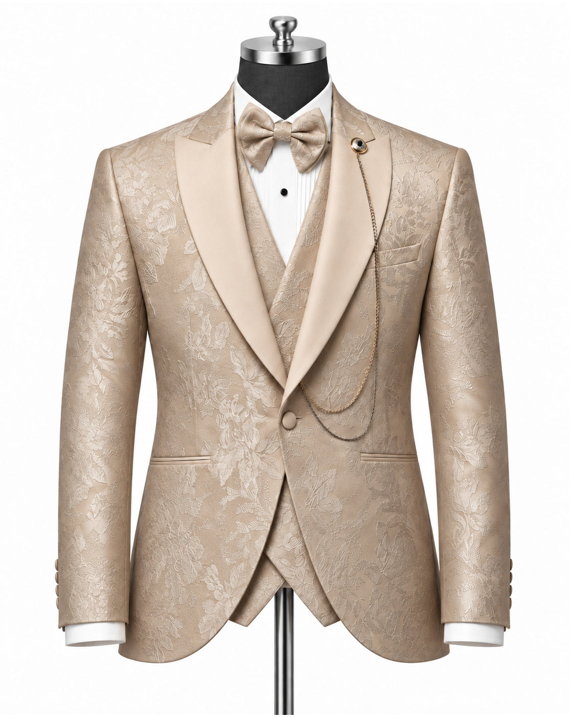 A men's formal tuxedo jacket with matching waistcoat and bow tie, displayed on a mannequin. The fabric is a champagne beige with a subtle floral damask pattern.