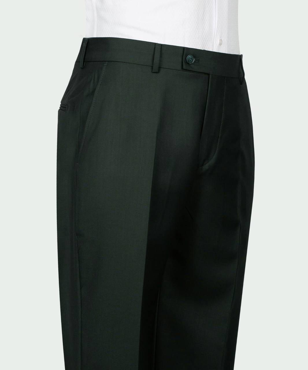 A close-up of a pair of dark olive green trousers worn with a white shirt, showing the front waistband, belt loops, and side pockets against a light gray background.