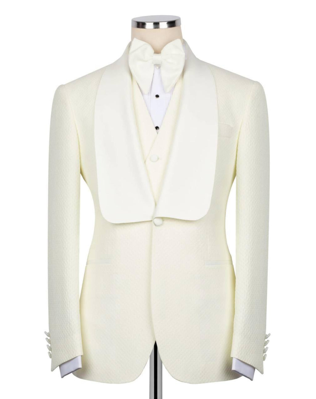 White tuxedo jacket with matching vest and bow tie on a mannequin against a white background