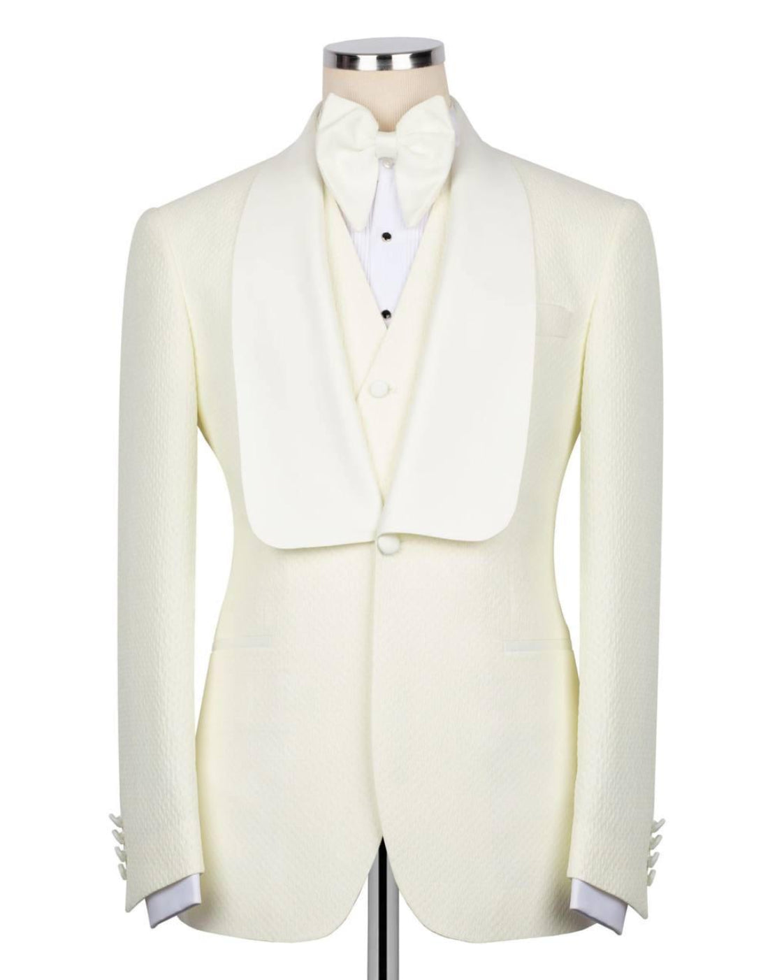 White tuxedo jacket with matching vest and bow tie on a mannequin against a white background