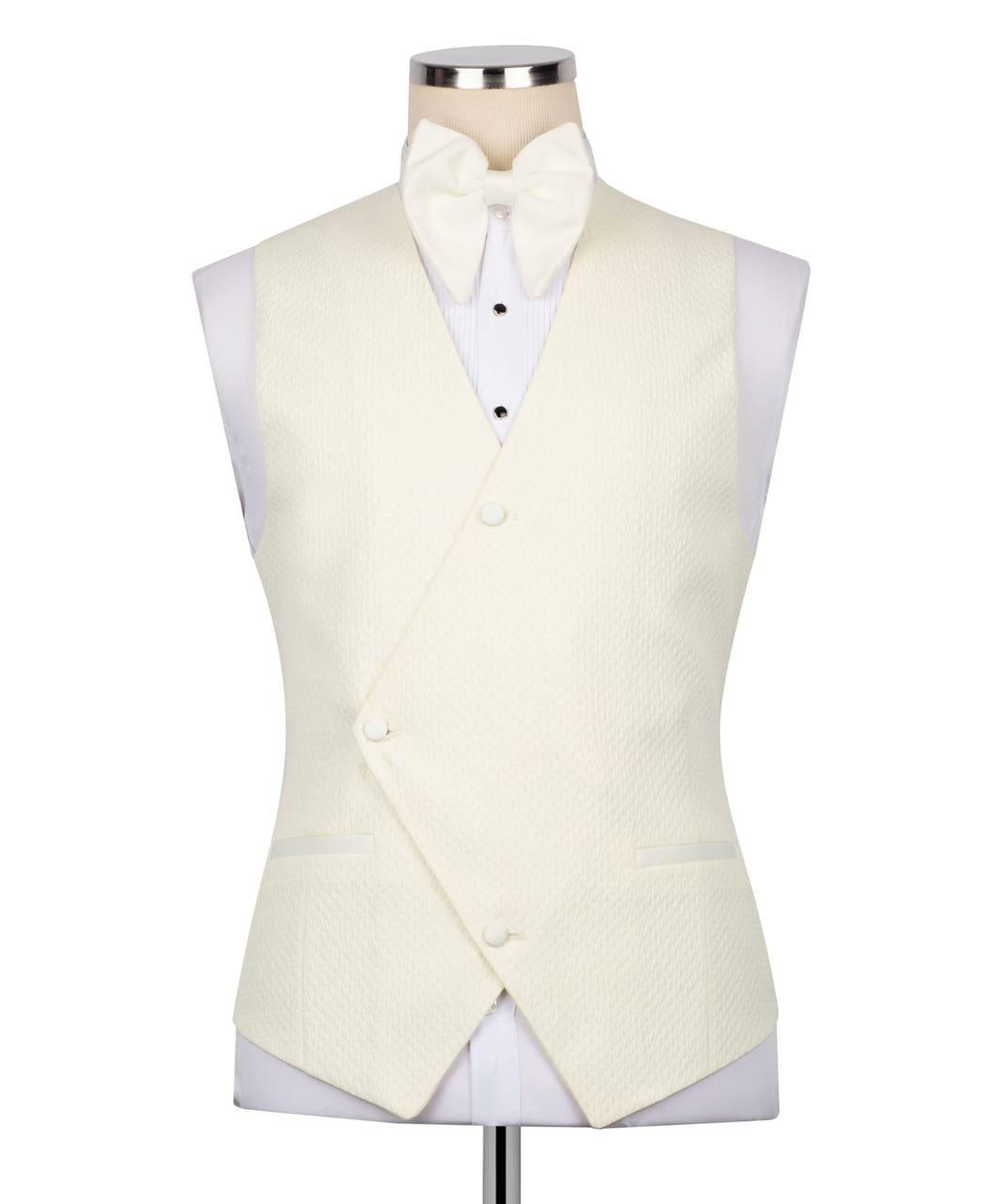 An ivory textured waistcoat vest displayed on a mannequin torso with a matching bow tie and white dress shirt, set against a plain white background.