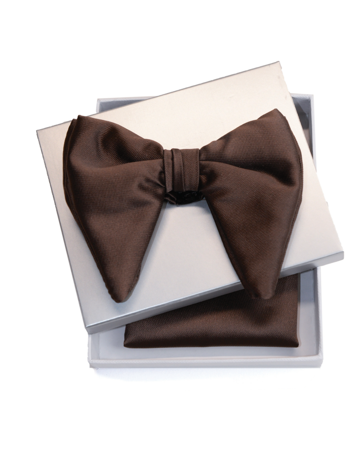 A pre-tied brown bow tie displayed on top of an open white gift box, with a matching brown pocket square folded inside, photographed on a clean white background.