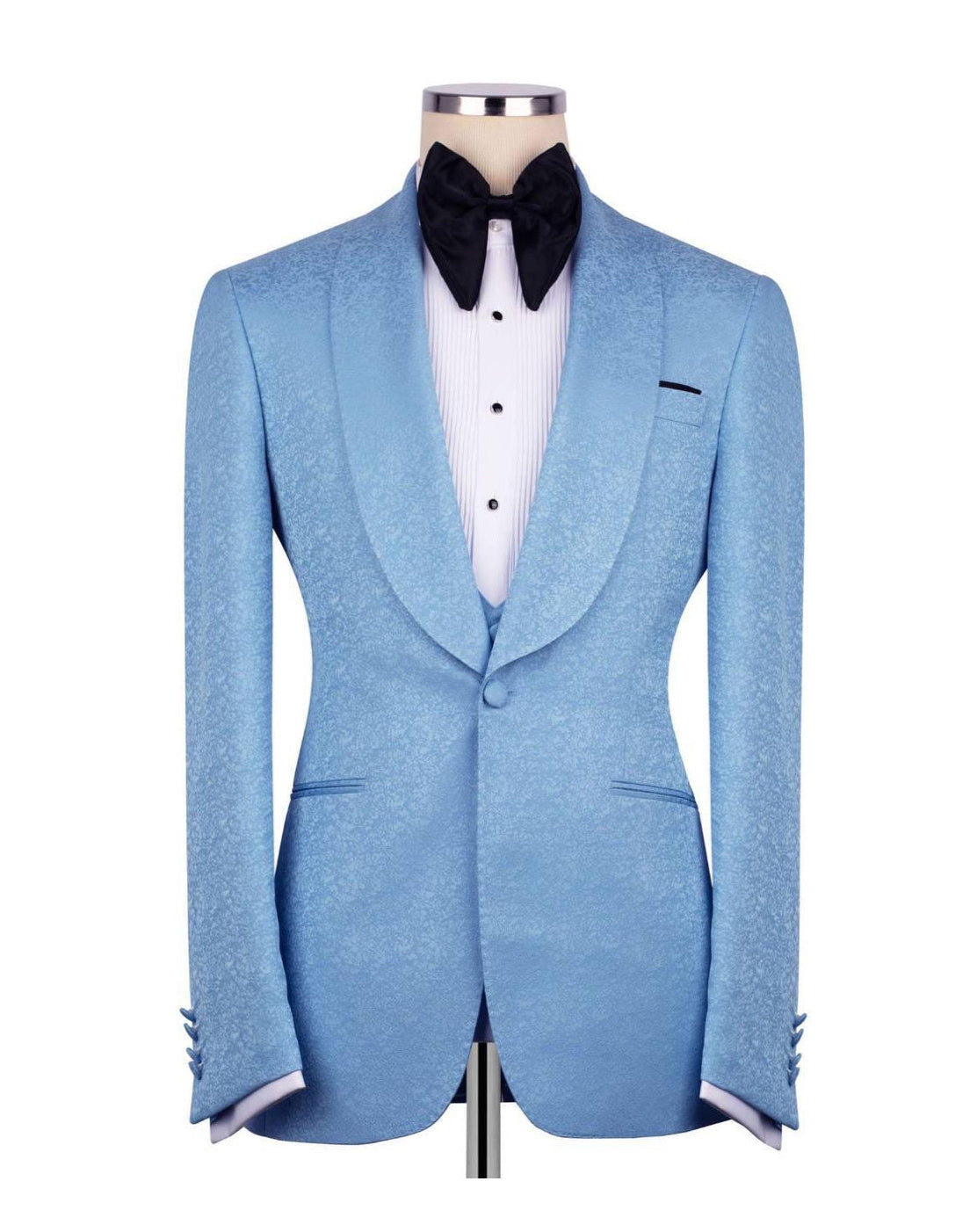 A light blue textured tuxedo jacket displayed on a mannequin torso, styled with a white pinstripe shirt, a black bow tie, and a black pocket square against a plain white background.