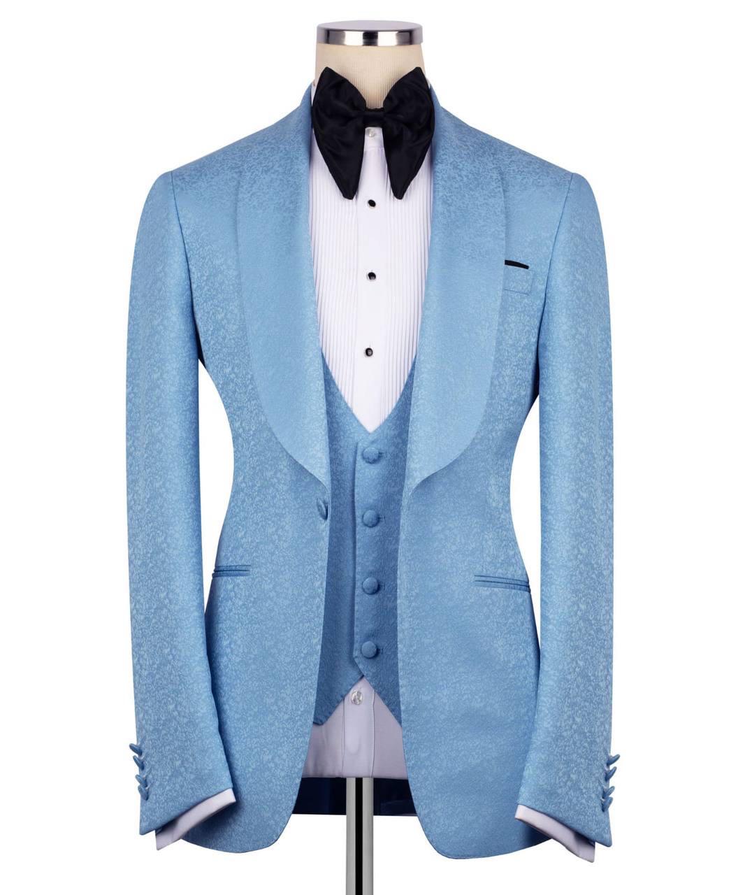 A light blue textured tuxedo jacket displayed on a mannequin with a matching vest, white pleated shirt, and black bow tie against a plain white background.