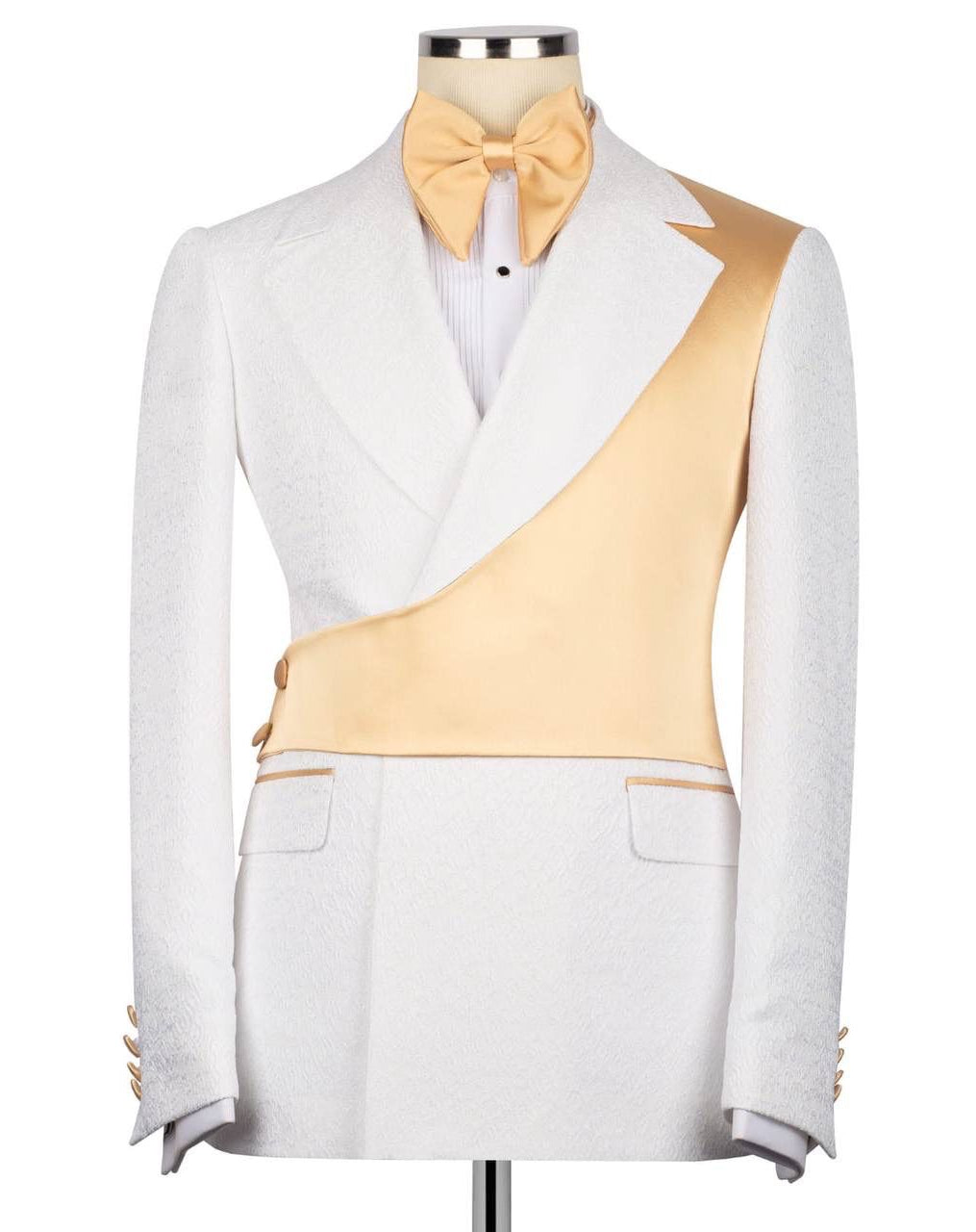 A white tuxedo jacket with a diagonal gold satin panel across the chest, styled on a mannequin with a gold bow tie and white dress shirt against a plain white background.