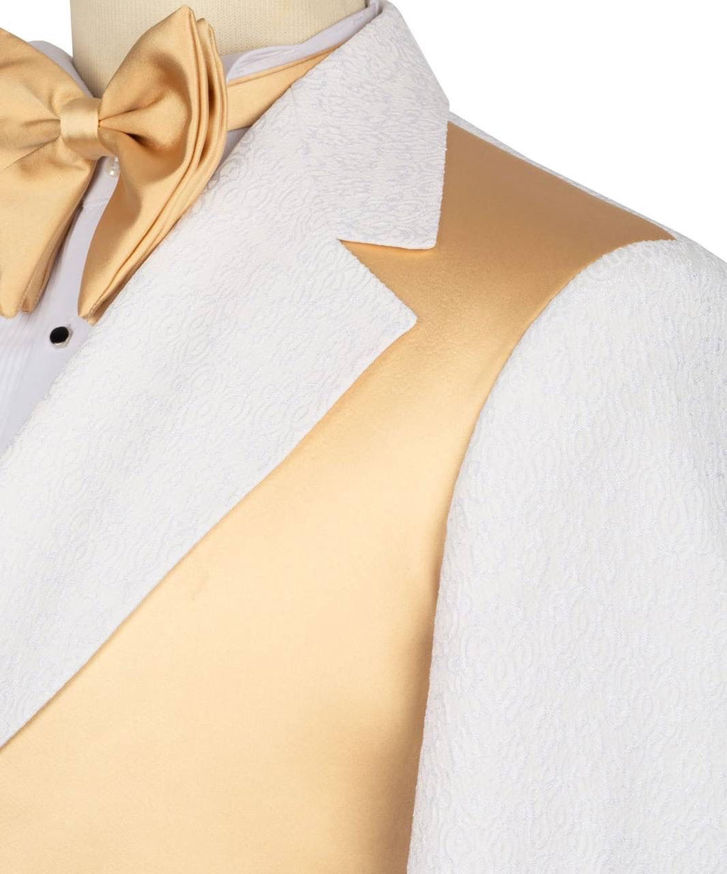 A close-up of a formal tuxedo outfit on a mannequin, featuring a white textured tuxedo jacket with satin lapels, a metallic gold vest, a white dress shirt, a gold satin bow tie, and a matching gold waistcoat.