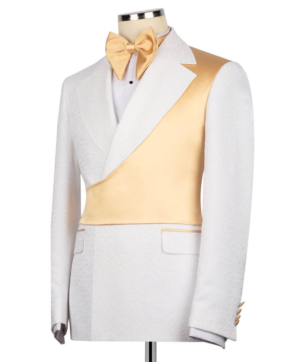 A white tuxedo jacket with a contrasting gold satin diagonal panel across the chest, styled on a mannequin with a matching gold satin bow tie.