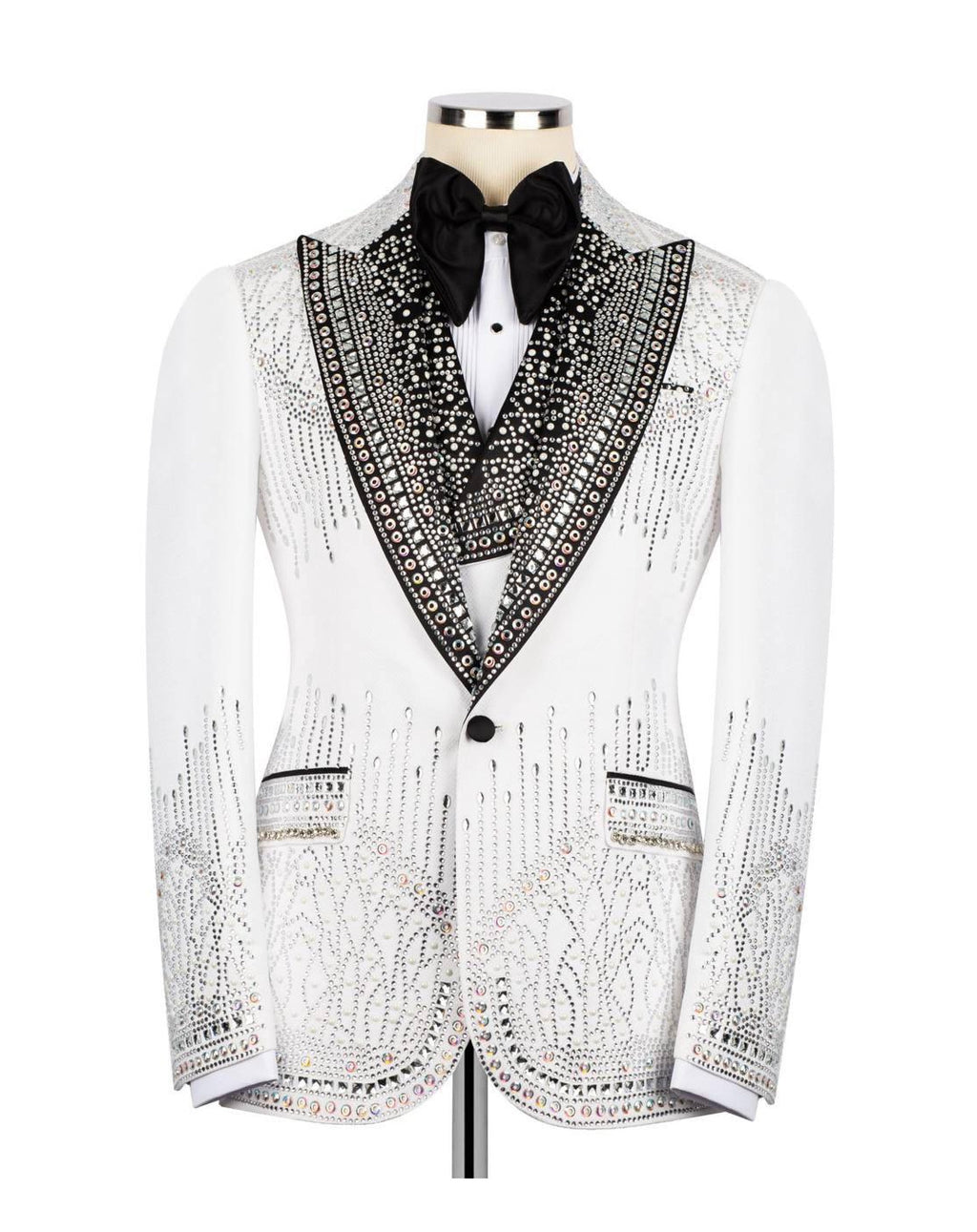 A white tuxedo jacket embellished with intricate black beading and sequins, styled on a mannequin with a black bow tie and white shirt against a plain white background.