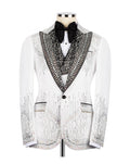 A white tuxedo jacket embellished with intricate black beading and sequins, styled on a mannequin with a black bow tie and white shirt against a plain white background.
