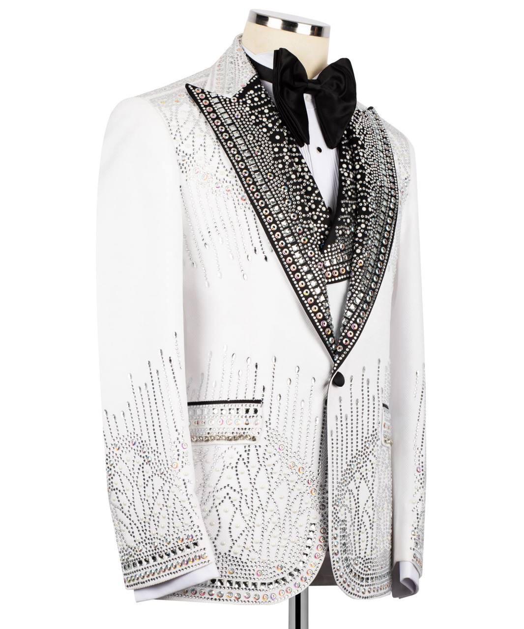 Elegant white tuxedo with black lapels and intricate detailing on a mannequin against a white background.