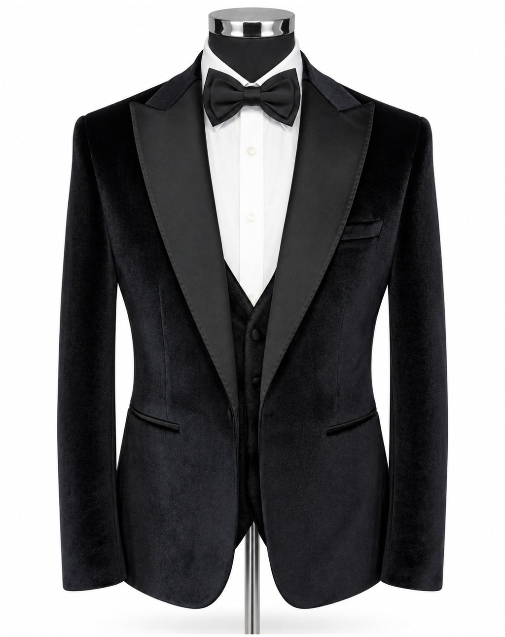A black velvet tuxedo jacket displayed on a mannequin torso, styled with a white dress shirt, black bow tie, and matching black vest against a plain white background.