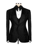 A black sequined tuxedo jacket displayed on a mannequin torso, styled with a white pleated tuxedo shirt, black bow tie, and black vest against a plain white background.