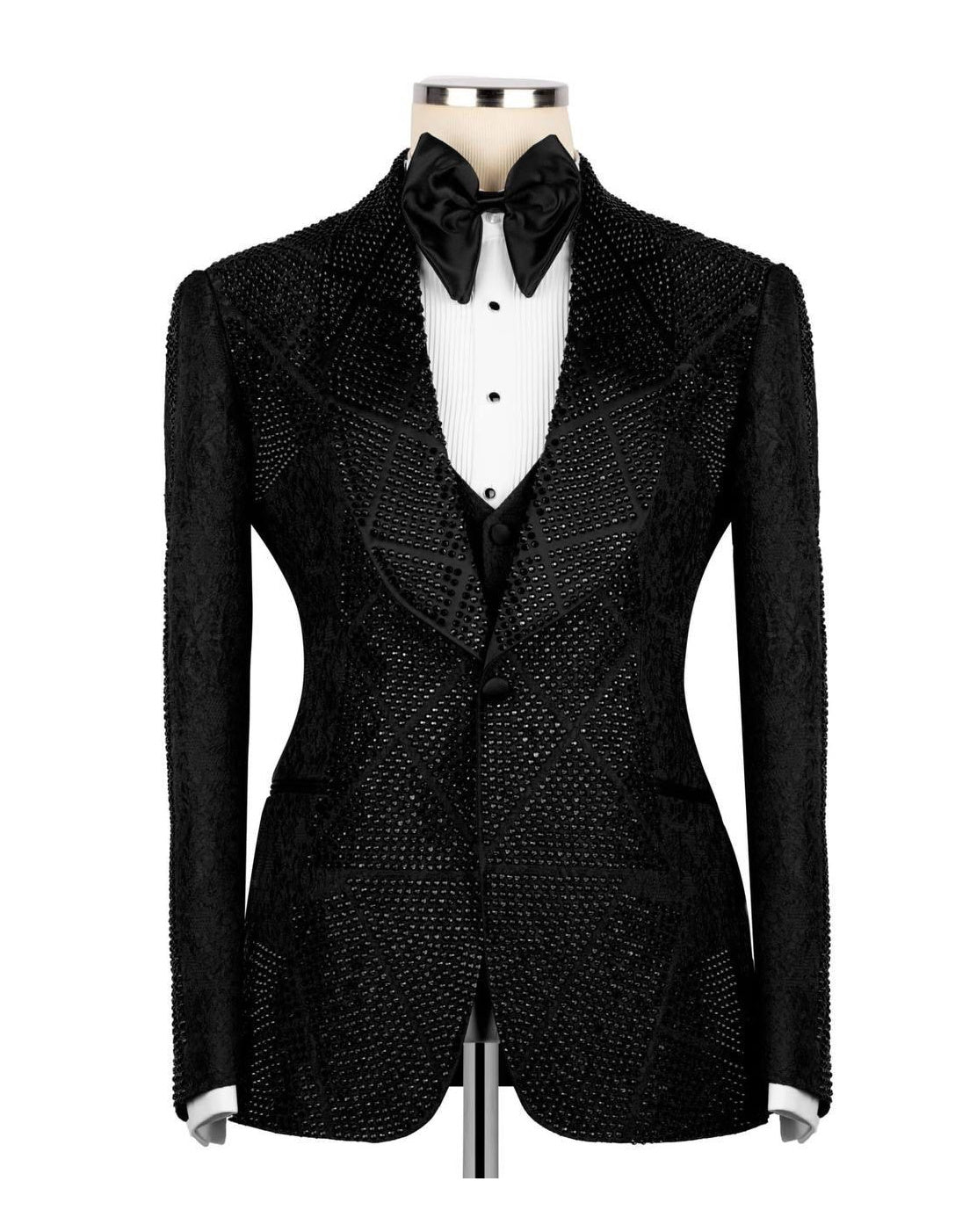 A black sequined tuxedo jacket displayed on a mannequin torso, styled with a white pleated tuxedo shirt, black bow tie, and black vest against a plain white background.