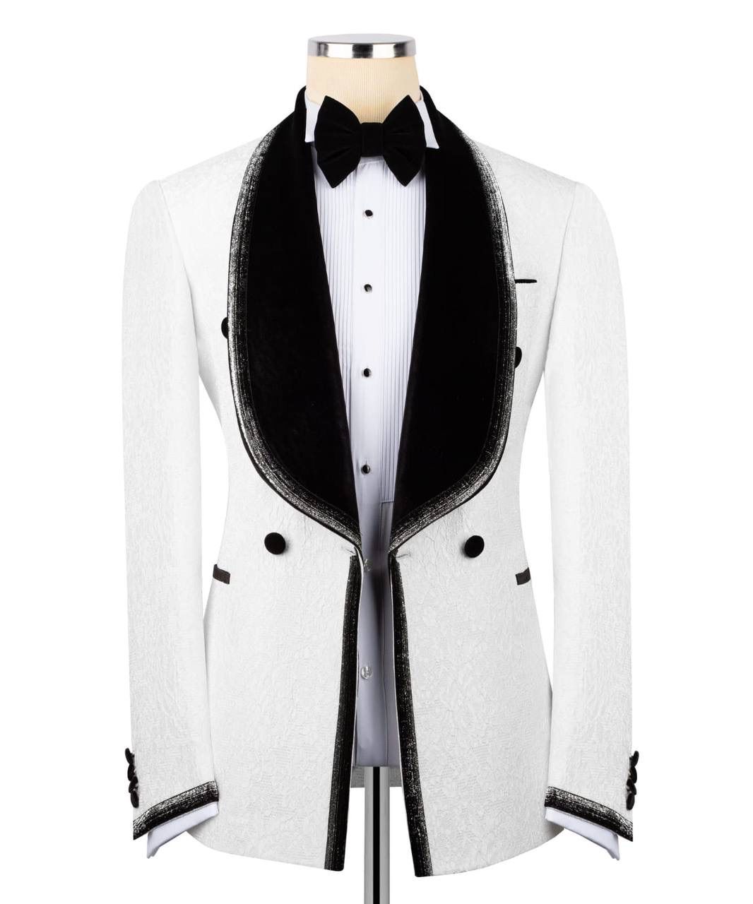 A white tuxedo jacket with black velvet shawl lapels, black trim, and a black bow tie, displayed on a mannequin torso over a white pinstripe shirt.
