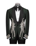 A dark green tuxedo jacket with black satin lapels and elaborate gold sequin and bead embroidery on the front and cuffs, displayed on a mannequin with a black bow tie and white shirt.