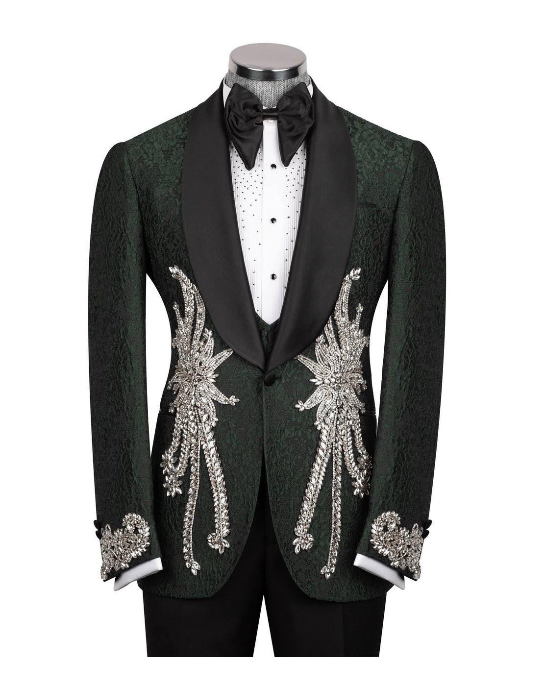 A dark green tuxedo jacket with black satin lapels and elaborate gold sequin and bead embroidery on the front and cuffs, displayed on a mannequin with a black bow tie and white shirt.