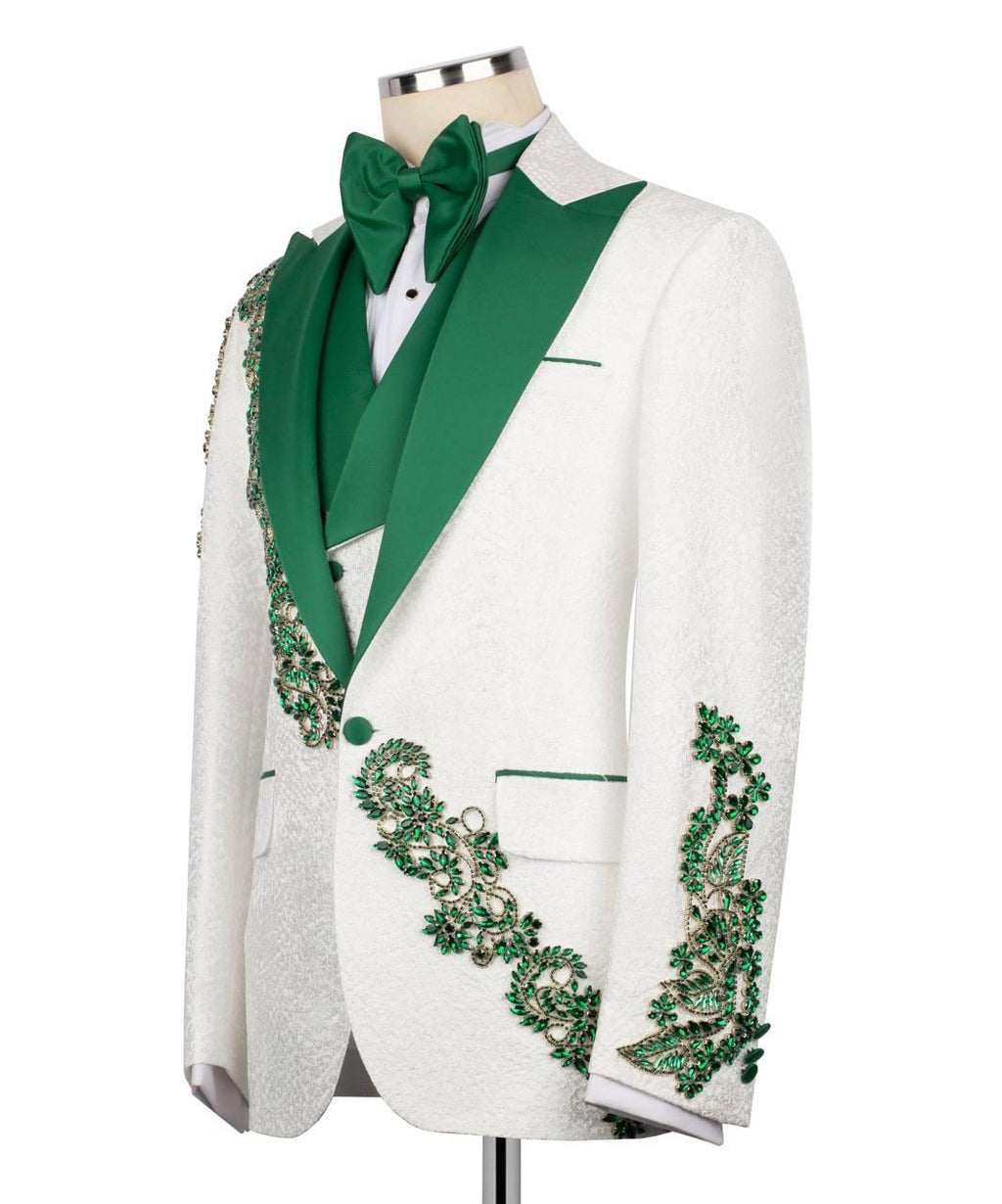 White tuxedo with green lapels and embellishments on a mannequin against a white background