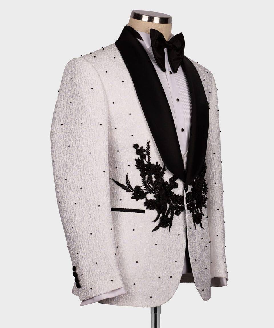 White tuxedo jacket with black floral embroidery on a mannequin against a white background