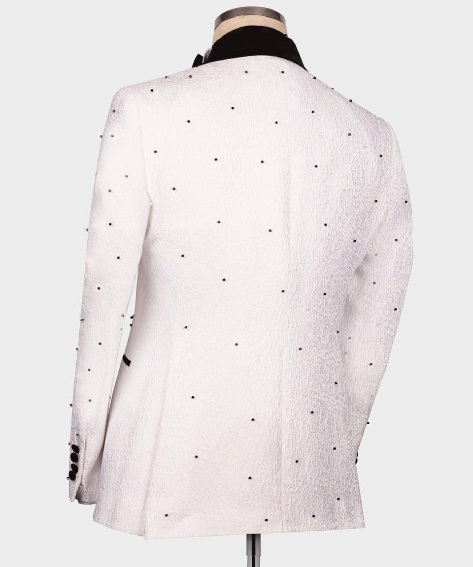 A white textured blazer jacket with small black polka dots, shown from the back on a mannequin with a black collar insert, against a light gray background.