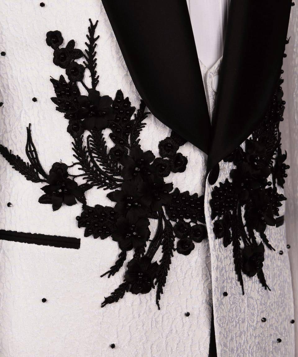 Black lace detailing on a white garment with black polka dots