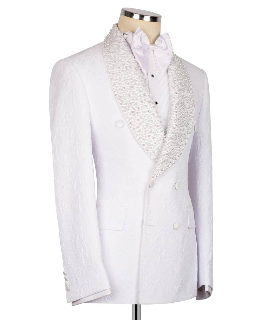 A white double-breasted tuxedo jacket with textured jacquard fabric and wide shawl lapels featuring a white floral pattern, displayed on a mannequin with a white shirt and bow tie.
