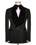 A black double-breasted tuxedo jacket with a heavily embellished beaded and sequined shawl collar, displayed on a mannequin with a white dress shirt and black bow tie against a plain white background.