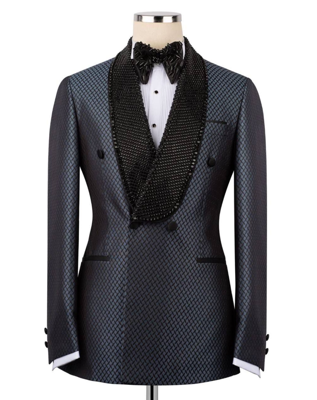 Black patterned tuxedo jacket with a bow tie on a mannequin against a white background
