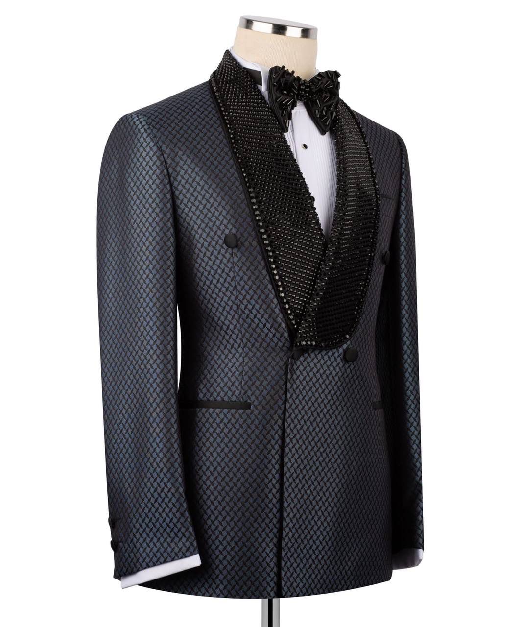 A men's tuxedo jacket displayed on a mannequin torso, featuring a textured dark gray and black micro-patterned body, a black beaded shawl collar, a white dress shirt, and a black bow tie.