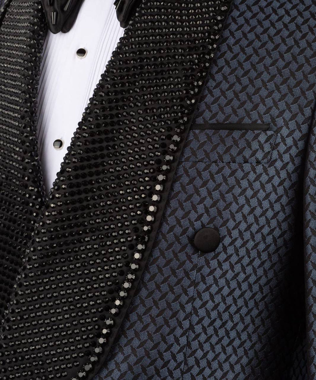 Close-up of a patterned suit jacket with a white shirt and black bow tie.