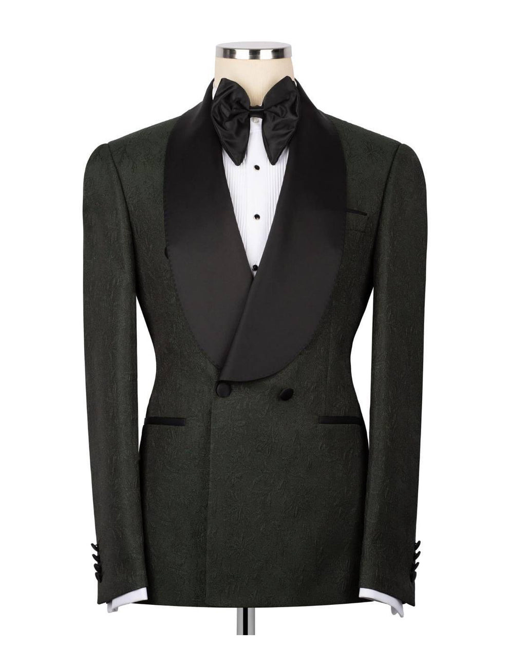 A dark green textured tuxedo jacket with black satin shawl lapels, styled on a mannequin with a black bow tie, white dress shirt, and black cummerbund against a white background.