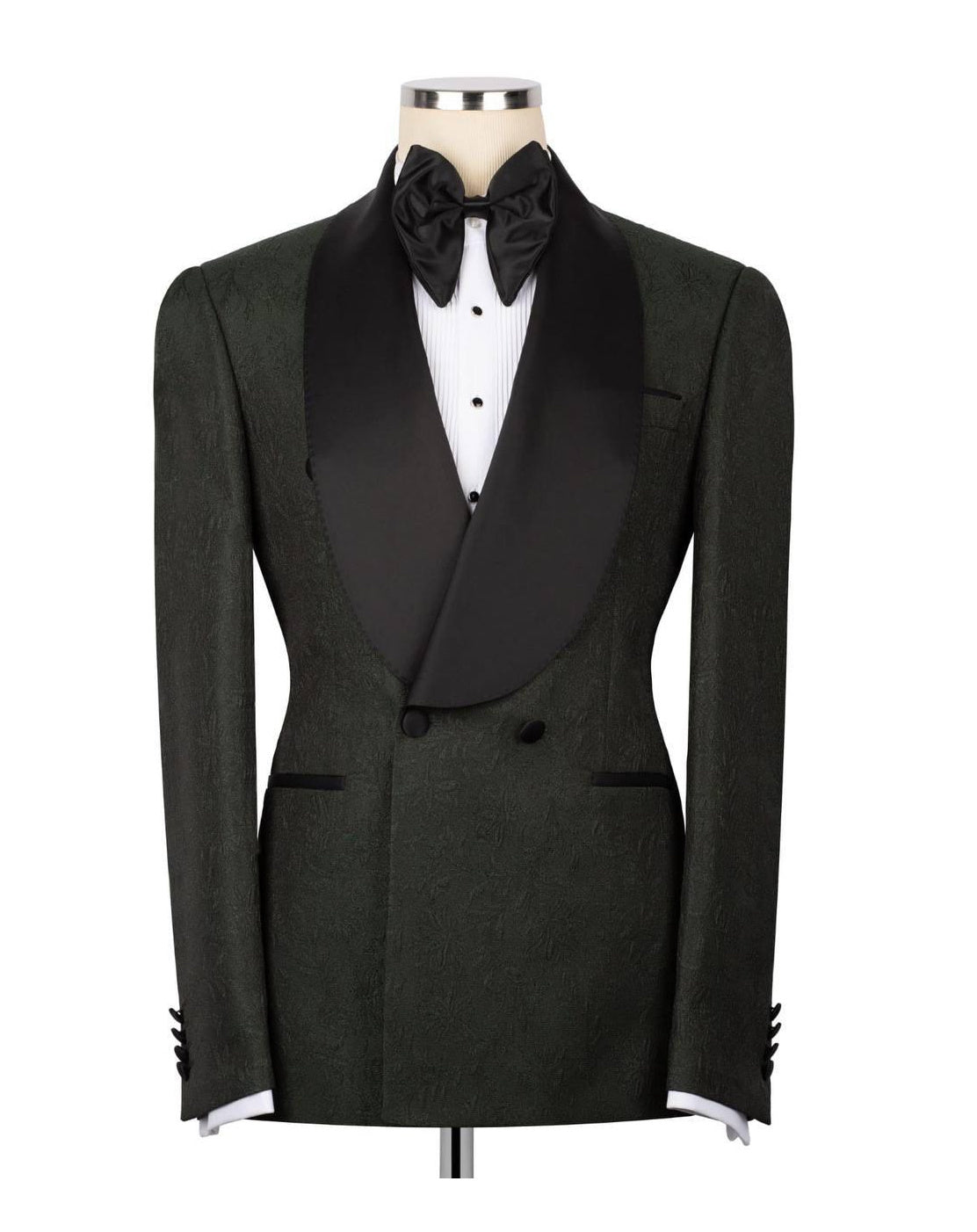 A dark green textured tuxedo jacket with black satin shawl lapels, styled on a mannequin with a black bow tie, white dress shirt, and black cummerbund against a white background.