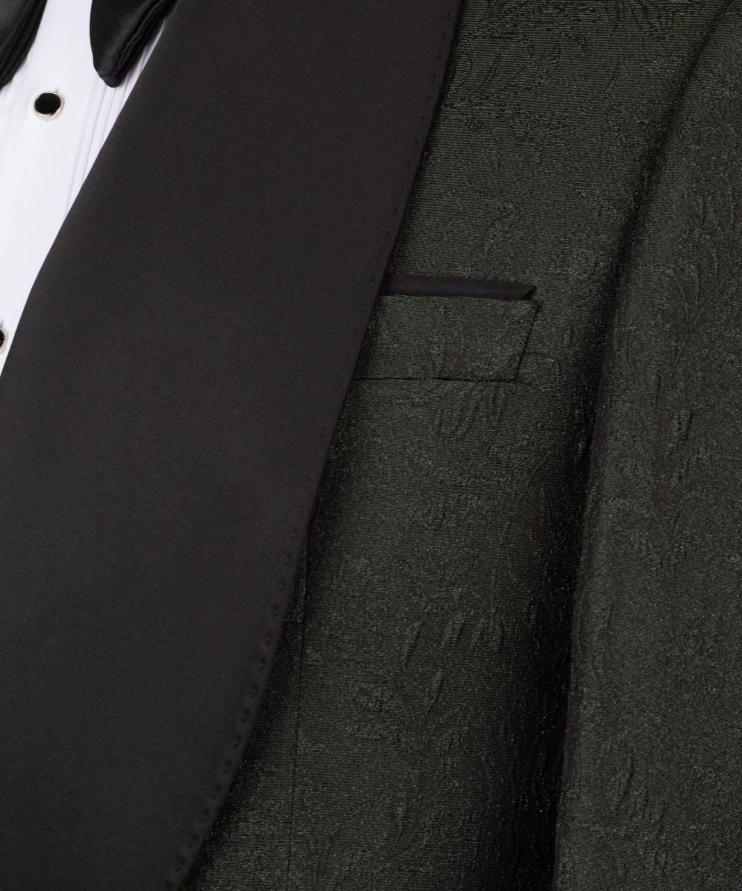 Close-up of a formal tuxedo jacket with a black satin lapel, black bow tie, and a textured dark green or charcoal jacquard body.