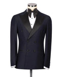 A navy blue double-breasted tuxedo jacket with black satin peak lapels, displayed on a mannequin torso with a black bow tie, white dress shirt, and white cufflinks against a light gray background.