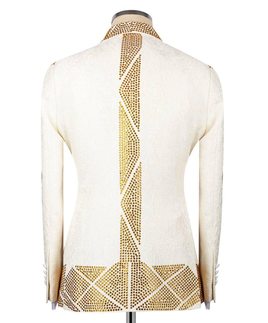An off-white textured blazer shown from the back on a mannequin, featuring prominent gold rhinestone geometric patterns running down the center back and across the lower hem.